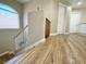 Upstairs hallway with laminate wood flooring, window, and white doors at 1508 Splinter Rock Way, North Las Vegas, NV 89031