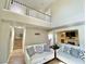 Cozy living room featuring neutral paint, wood floors, comfortable sofas and stairs to the second level at 1508 Splinter Rock Way, North Las Vegas, NV 89031