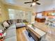 Inviting living room with wood floors, modern sectional, open layout with view to the kitchen and abundant natural light at 1508 Splinter Rock Way, North Las Vegas, NV 89031