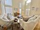 Bright living room with high ceilings, large windows, and comfortable white sofas and tasteful décor at 1508 Splinter Rock Way, North Las Vegas, NV 89031