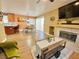 Cozy living room with a fireplace, wood floors, and access to the dining area and kitchen at 1508 Splinter Rock Way, North Las Vegas, NV 89031