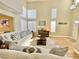 Bright living room featuring high ceilings, large windows, wood floors, and comfortable white sofas at 1508 Splinter Rock Way, North Las Vegas, NV 89031