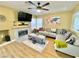 Inviting living room with a cozy fireplace, TV, ceiling fan, and stylish decor perfect for relaxation at 1508 Splinter Rock Way, North Las Vegas, NV 89031