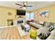 Inviting living room with wood floors, modern sectional, fireplace, and ample natural light at 1508 Splinter Rock Way, North Las Vegas, NV 89031