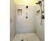 This shower features a rainfall shower head, handheld shower head, and two built-in shampoo shelves at 1508 Splinter Rock Way, North Las Vegas, NV 89031