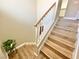 Staircase with wood-look steps, white risers, and white and wooden handrail at 1508 Splinter Rock Way, North Las Vegas, NV 89031