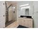 Bathroom featuring tiled walk-in shower with glass door and modern vanity at 1616 Langston Hughes St, Henderson, NV 89052