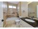 Bathroom with a soaking tub and a granite countertop vanity at 1616 Langston Hughes St, Henderson, NV 89052