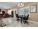 Open dining and living area with tile floors, neutral paint, and window shutters at 1616 Langston Hughes St, Henderson, NV 89052