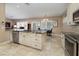 Well-lit kitchen featuring an island with granite countertops and stainless steel appliances at 1616 Langston Hughes St, Henderson, NV 89052