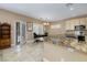 Bright kitchen featuring granite countertops, light wood cabinetry, and tile flooring at 1616 Langston Hughes St, Henderson, NV 89052