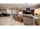 Inviting living room with tile floors, plantation shutters, and comfortable seating at 1616 Langston Hughes St, Henderson, NV 89052