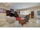 Inviting living room with tile floors, plantation shutters, and comfortable seating at 1616 Langston Hughes St, Henderson, NV 89052