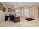 Bright home office with tile floors, plantation shutters, and a modern desk setup at 1616 Langston Hughes St, Henderson, NV 89052