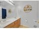 Bathroom boasts a dual sink vanity, ample lighting, and stylish decorative shelving at 1646 Little Crow Ave, Las Vegas, NV 89123