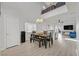 Bright dining area with wood floors, a view of the loft, and a modern light fixture at 1646 Little Crow Ave, Las Vegas, NV 89123