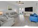 Inviting living room with neutral tones, wood floors, and sliding glass doors to the backyard at 1646 Little Crow Ave, Las Vegas, NV 89123