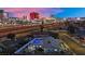 Aerial view of home with pool, showcasing a city skyline backdrop against a twilight sky at 1805 Ivanhoe Way, Las Vegas, NV 89102