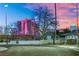 Exterior view of a home with trees in front of it, with Las Vegas buildings visible in the background at 1805 Ivanhoe Way, Las Vegas, NV 89102