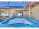 Relaxing hot tub with clear water, complemented by a spiral staircase and backyard view at 1805 Ivanhoe Way, Las Vegas, NV 89102