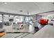 Open-concept living room with sleek modern furnishings, a view of the backyard pool, and lots of natural light at 1805 Ivanhoe Way, Las Vegas, NV 89102