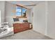 Unfinished office space, featuring a window with a view of a tree and dark brown set of drawers at 1805 Ivanhoe Way, Las Vegas, NV 89102