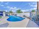 Backyard pool area with blue swimming pool, white brick fence and furniture at 1805 Ivanhoe Way, Las Vegas, NV 89102