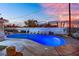 Backyard pool area featuring a kidney-shaped pool with lounge chairs and a clear view of the twilight sky at 1805 Ivanhoe Way, Las Vegas, NV 89102