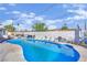 Backyard pool area with blue swimming pool, white brick fence, and furniture at 1805 Ivanhoe Way, Las Vegas, NV 89102