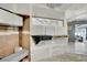 Unfinished room with white cabinets, a window, and view into a living space at 1805 Ivanhoe Way, Las Vegas, NV 89102