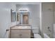 Bathroom featuring a single sink vanity, mirror, and a shower-tub combo at 1881 W Alexander Rd # 1135, North Las Vegas, NV 89032