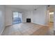 Open-concept living room featuring fireplace, sliding glass doors, and tile flooring at 1881 W Alexander Rd # 1135, North Las Vegas, NV 89032