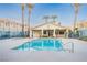 Community pool with clear blue water surrounded by palm trees and building at 1881 W Alexander Rd # 1135, North Las Vegas, NV 89032