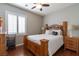 Inviting bedroom featuring a wood bed frame, side tables, and a window providing natural light and a relaxing atmosphere at 1905 Sirocco Ct, Las Vegas, NV 89117