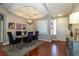 Elegant dining room featuring a tray ceiling, modern chandelier, and stylish decor at 1905 Sirocco Ct, Las Vegas, NV 89117