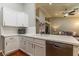 Contemporary kitchen with stainless steel dishwasher and sink overlooking living room at 1905 Sirocco Ct, Las Vegas, NV 89117