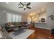 Open concept living room with hardwood floors, neutral paint, and large windows with plantation shutters at 1905 Sirocco Ct, Las Vegas, NV 89117