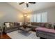 Comfortable living room featuring a plush sectional sofa, modern ceiling fan, and abundant natural light at 1905 Sirocco Ct, Las Vegas, NV 89117