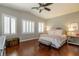 Serene main bedroom featuring hardwood floors, shuttered windows, and stylish décor at 1905 Sirocco Ct, Las Vegas, NV 89117