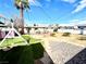 Backyard with artificial turf, gravel landscaping, a playhouse, and a swing set at 1908 Linden Ave, Las Vegas, NV 89101