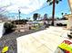 Spacious backyard with a patio, gravel landscaping, mature trees, and play structures at 1908 Linden Ave, Las Vegas, NV 89101