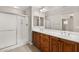 Bathroom featuring dual sinks, a large mirror, and a glass-enclosed shower at 1968 Granemore St, Las Vegas, NV 89135