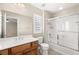 Well-lit bathroom features vanity and shower-tub combo, accented with modern fixtures at 1968 Granemore St, Las Vegas, NV 89135