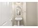 A charming pedestal sink complements the neutral walls and flooring in the powder room at 1968 Granemore St, Las Vegas, NV 89135