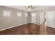 Bright bedroom with a ceiling fan, neutral walls, and wood floors at 1968 Granemore St, Las Vegas, NV 89135