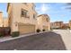 Two-story beige homes with tile roofs, two-car garages, and manicured front yards at 1968 Granemore St, Las Vegas, NV 89135