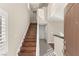 Bright foyer features stylish wood stairs, tiled floors, neutral paint, and an open concept design at 1968 Granemore St, Las Vegas, NV 89135