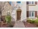 Inviting front entrance to a home with a decorative arched doorway, brick pavers, and neat landscaping at 1968 Granemore St, Las Vegas, NV 89135