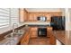 Kitchen with wooden cabinets, stainless steel appliances, and granite countertops at 1968 Granemore St, Las Vegas, NV 89135