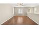 Spacious living room featuring hardwood flooring, plantation shutters and a ceiling fan at 1968 Granemore St, Las Vegas, NV 89135